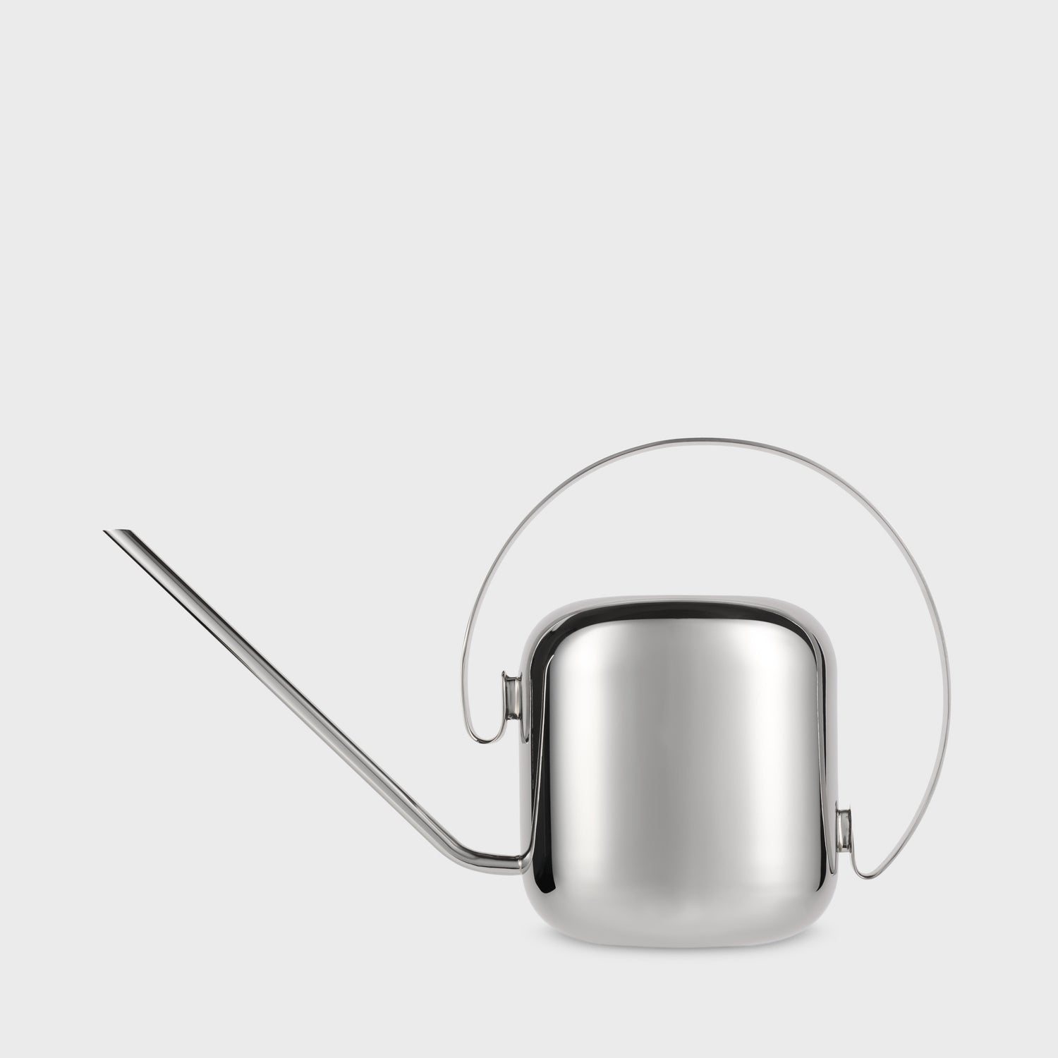 Silver watering can on a light gray background