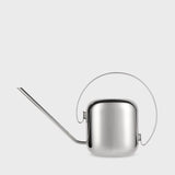 Silver watering can on a light gray background