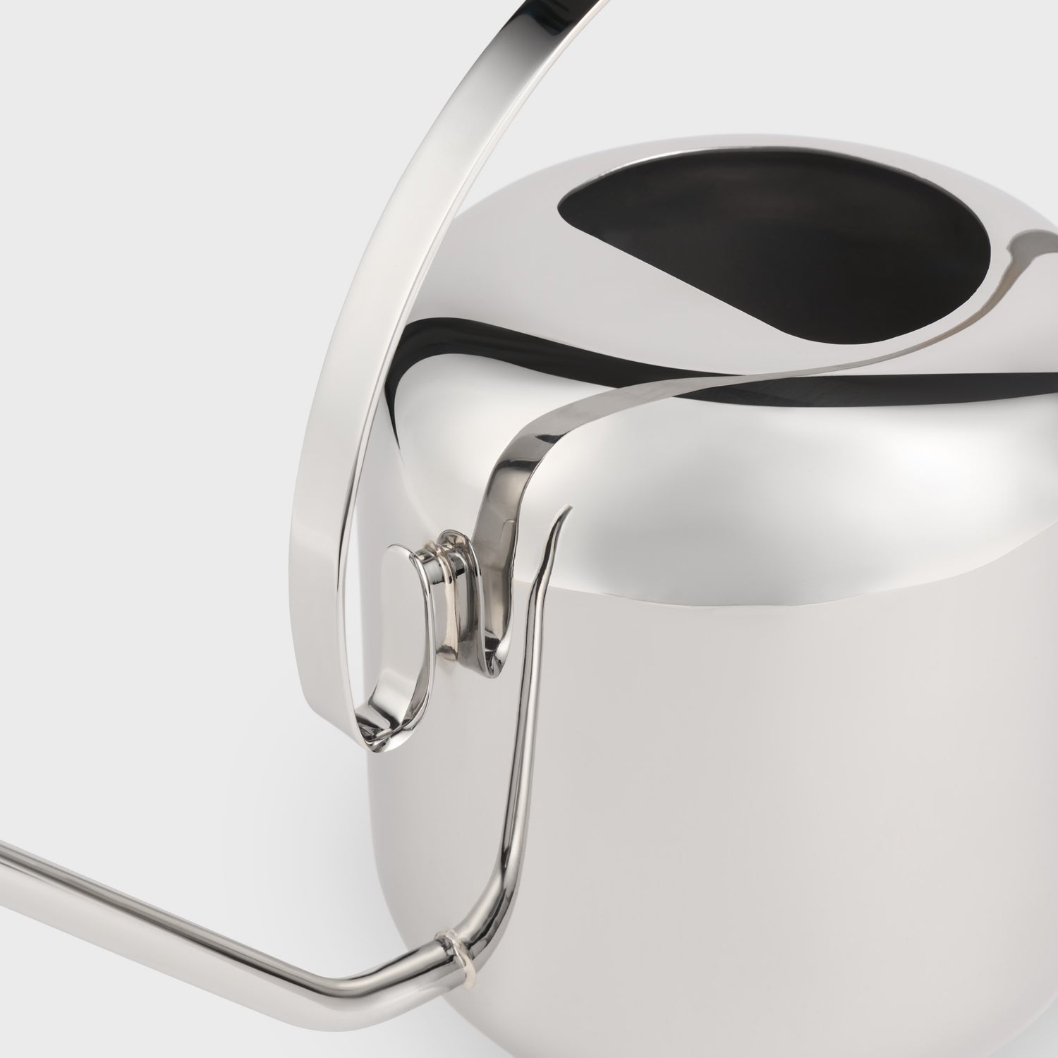 Close-up of a silver watering can on a white background